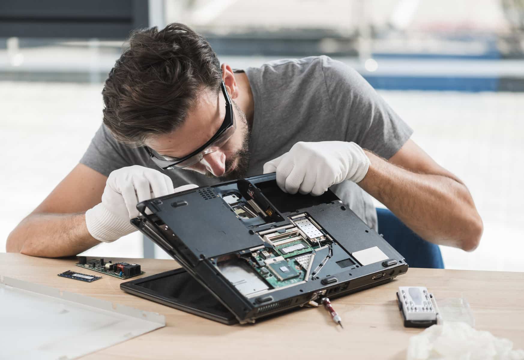 Technician working on laptop components